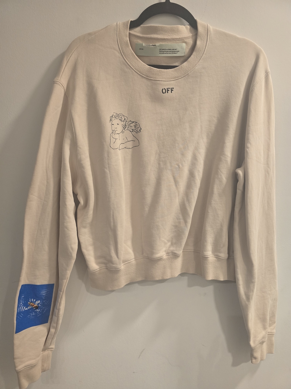 Off-White Cream Crewneck with Angel Line Art and Blue Graphic Patch